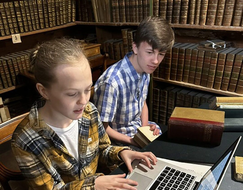 Two young Turriff brothers, Ollie and Harry Ferguson researching the origins of the burger in Craigston library